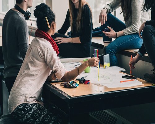 Group of diverse people having a calm discussion over coffee